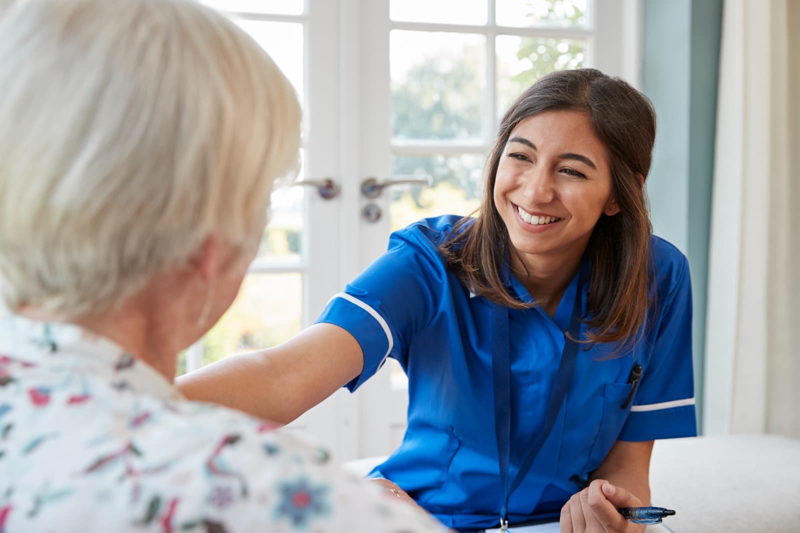 Care professional talking with an older person at home